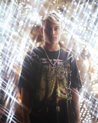 a young man wearing a t - shirt with a dragon on it